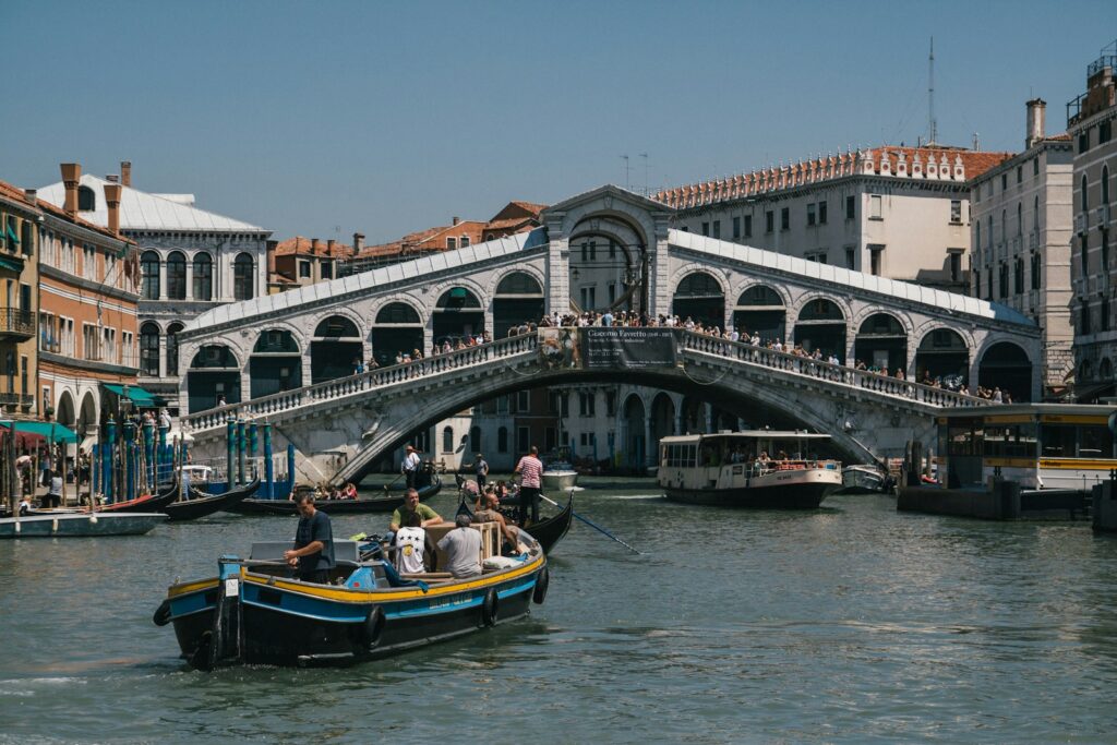 people riding on blue boat on river during daytime